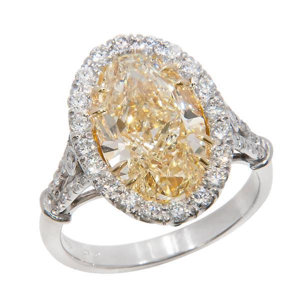 View Split Shank Halo Style Oval Shape Natural Fancy Yellow and White Diamond Ring Set in Platinum